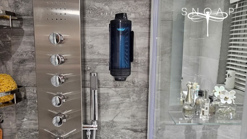 SNOAP refillable soap dispenser system mounted in a modern shower, replacing liquid bottles with eco-friendly soap and shampoo bars for sustainable washing.
