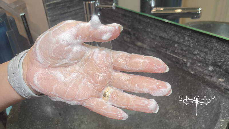 Powdered soap from SNOAP dispenser falling into hand demonstrating gentle hand care