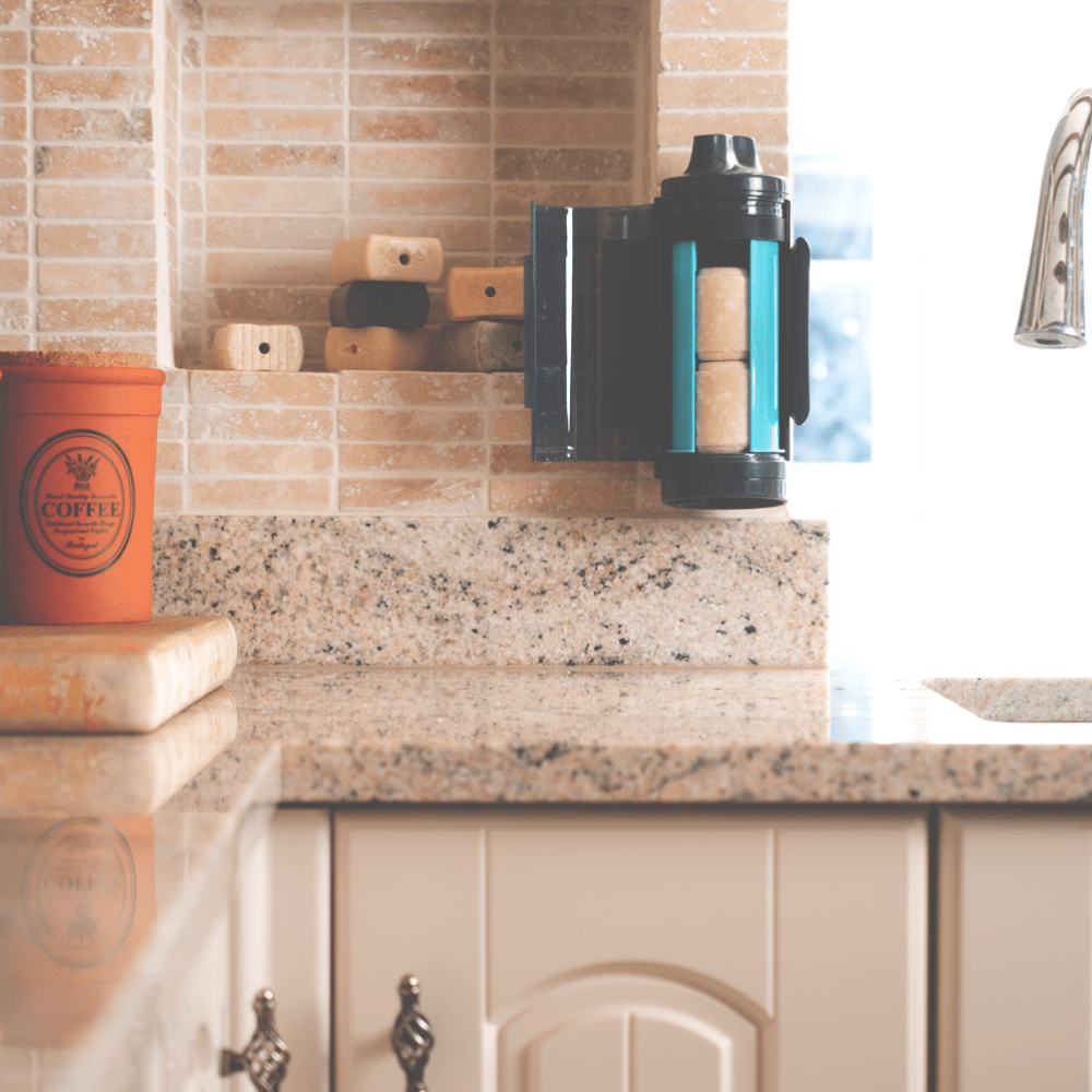 SNOAP Dispenser in Anthracite Grey Wall mounted in kitchen with door open showing 2 soap bars inside