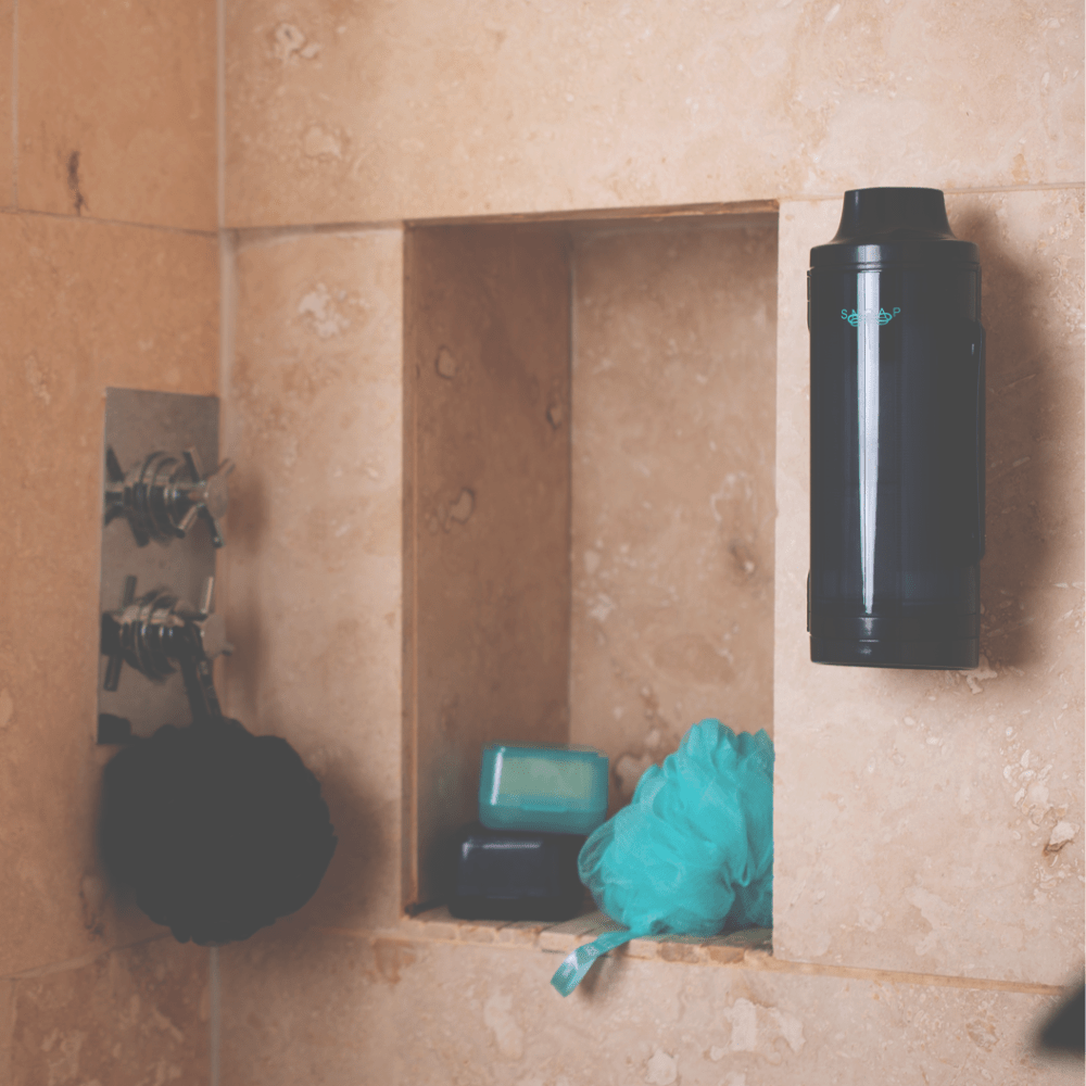 SNOAP Dispenser in Anthracite Grey Wall mounted in shower next to other SNOAP accessories including shower puffs and soap boxes