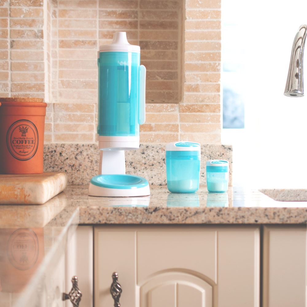 SNOAP Dispenser in white & SNOAP blue, counter mounted in kitchen with SNOAP shaker style dispensers next to the dispenser.