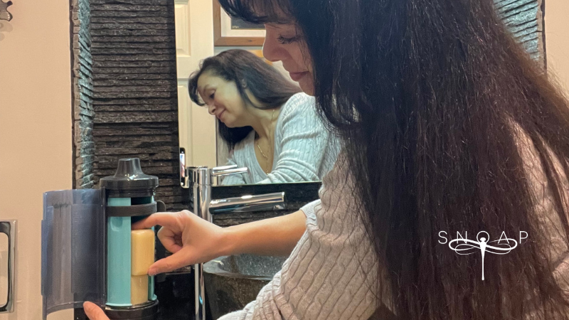 SNOAP refillable soap dispenser system in a modern bathroom setting